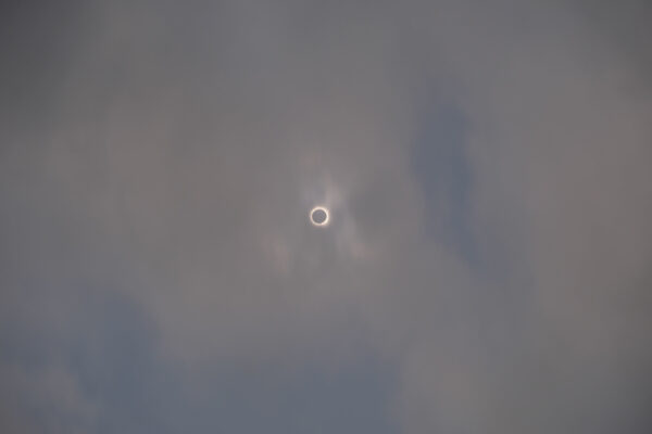 A total solar eclipse in a cloudy sky